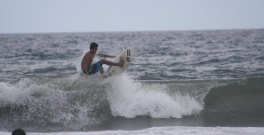 Surfer comes off the lip of a wave on Pensacola Beach, Florida