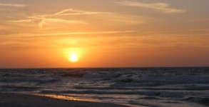 New Year's Day Sunrise with the full sun and waves to surf at Pensacola Beach